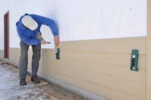 Man-installing-fibrous-cement